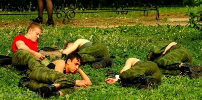 Russian soldiers taking a nap on a grass