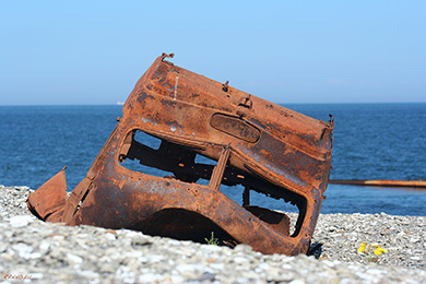 Rusted truck wreck on beach of Pakri island