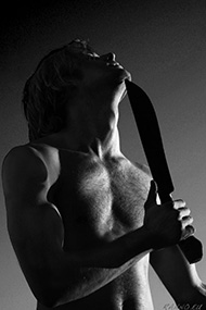 Alens with machete under chin