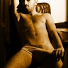 Ali in underwear on a chair